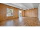 Spacious living room with wood paneled walls, beamed ceilings, and sliding door to patio at 9700 E Iliff Ave # B13, Denver, CO 80231