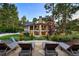 Expansive backyard with manicured lawn, stone patio, and lounge chairs offers a serene space for relaxation at 2130 Avenida Del Sol, Castle Rock, CO 80104