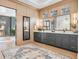 Spa-like bathroom with double vanity, wood paneling, decorative mirrors, and modern fixtures at 2130 Avenida Del Sol, Castle Rock, CO 80104