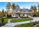 Beautiful home showcasing a manicured lawn, stone accents, and elegant architectural details, offering great curb appeal at 2130 Avenida Del Sol, Castle Rock, CO 80104