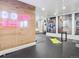Home gym with workout equipment, mirrored walls, and a motivating neon 