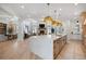 Spacious kitchen with large island, stainless steel appliances, and access to the living room with a fireplace at 2130 Avenida Del Sol, Castle Rock, CO 80104