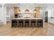Stylish kitchen with an expansive island, pendant lighting, stainless steel appliances, and custom cabinetry at 2130 Avenida Del Sol, Castle Rock, CO 80104