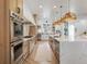Well-appointed kitchen featuring an expansive island, stainless steel appliances, custom cabinetry, and a sleek design at 2130 Avenida Del Sol, Castle Rock, CO 80104