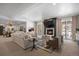 Basement living room featuring a cozy fireplace, large sectional sofa, and sliding glass doors at 2130 Avenida Del Sol, Castle Rock, CO 80104