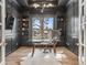 Home office featuring custom bookshelves, large window, and a modern glass desk at 2130 Avenida Del Sol, Castle Rock, CO 80104