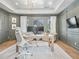 Well-lit home office with elegant gray walls, hardwood floors, and a large window providing a serene view at 2130 Avenida Del Sol, Castle Rock, CO 80104