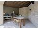 Covered outdoor kitchen with pizza oven, grill, and a marble countertop island at 2130 Avenida Del Sol, Castle Rock, CO 80104