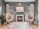 Cozy sitting area with fireplace, neutral decor, lots of light and view of the winter landscape at 2130 Avenida Del Sol, Castle Rock, CO 80104