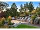 Beautiful outdoor patio with sun loungers nestled in a lush, landscaped yard at 2130 Avenida Del Sol, Castle Rock, CO 80104