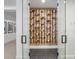 Climate-controlled wine room featuring custom racks with glass doors, and tiled floor at 2130 Avenida Del Sol, Castle Rock, CO 80104