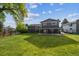Spacious backyard view with a well-maintained lawn and a covered patio area, perfect for outdoor entertaining at 6545 S Balsam Ct, Littleton, CO 80123