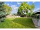 Expansive backyard featuring a lush green lawn and mature trees, providing a serene outdoor space at 6545 S Balsam Ct, Littleton, CO 80123