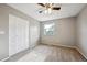Bedroom featuring carpet, closet, neutral paint, and a window offering natural light at 6545 S Balsam Ct, Littleton, CO 80123