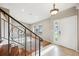 Bright entryway featuring tile floors, decorative staircase and a window, creating an inviting welcome at 6545 S Balsam Ct, Littleton, CO 80123