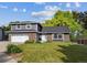 Charming two-story home with a well-maintained lawn, brick accents, a new roof and attached garage at 6545 S Balsam Ct, Littleton, CO 80123