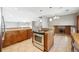 Well-lit kitchen with granite countertops, stainless steel appliances overlooking dining area and fireplace at 6545 S Balsam Ct, Littleton, CO 80123