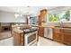 Beautifully designed kitchen featuring stainless steel appliances, granite countertops, and wooden cabinets at 6545 S Balsam Ct, Littleton, CO 80123