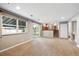 Spacious living room featuring a sliding glass door to the backyard and stair access at 6545 S Balsam Ct, Littleton, CO 80123