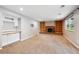 Bright living room with fireplace, custom built-ins and adjacent wet bar area at 6545 S Balsam Ct, Littleton, CO 80123