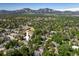 Wide shot showing the property amidst a leafy neighborhood with the mountains visible in the distance at 5523 Stonewall Pl, Boulder, CO 80303