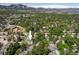Overhead shot showcasing the house and its location within a green, residential area with mountain views at 5523 Stonewall Pl, Boulder, CO 80303