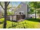 Backyard featuring a wooden fence, well-maintained lawn, and mature trees at 5523 Stonewall Pl, Boulder, CO 80303