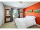 Bright bedroom featuring an orange accent wall and a comfortable bed at 5523 Stonewall Pl, Boulder, CO 80303