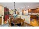 A cozy dining room with views of the kitchen and front entrance with hardwood floors at 5523 Stonewall Pl, Boulder, CO 80303