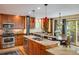 Well-lit kitchen with granite counters, a stainless-steel dishwasher, and wood cabinets at 5523 Stonewall Pl, Boulder, CO 80303