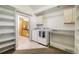Spacious laundry room with shelving, countertop space, and a washer/dryer at 5523 Stonewall Pl, Boulder, CO 80303
