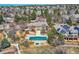Aerial view of the property with a swimming pool, expansive yard, and mature trees at 32 Silver Fox Cir, Greenwood Village, CO 80121