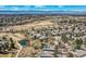 Stunning aerial view showcasing the neighborhood, open space, and mountain views at 32 Silver Fox Cir, Greenwood Village, CO 80121