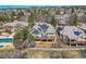 Aerial view of the home with a spacious deck, solar panels, and landscaped backyard at 32 Silver Fox Cir, Greenwood Village, CO 80121