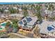 Aerial view of a property with mature trees and solar panels on the roof at 32 Silver Fox Cir, Greenwood Village, CO 80121