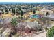 Overhead view featuring a large home with a lush backyard, mature landscaping, and neighborhood amenities at 32 Silver Fox Cir, Greenwood Village, CO 80121