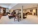 Open basement featuring a fireplace, a seating area, and kitchenette, perfect for entertaining at 32 Silver Fox Cir, Greenwood Village, CO 80121