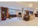 Finished basement featuring a TV, fireplace, built-in shelving, and comfortable seating area at 32 Silver Fox Cir, Greenwood Village, CO 80121
