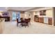 Spacious basement featuring a dining table, kitchenette, and access to the backyard patio at 32 Silver Fox Cir, Greenwood Village, CO 80121