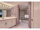 Bathroom featuring a vanity with a large mirror and a shower with glass doors at 32 Silver Fox Cir, Greenwood Village, CO 80121