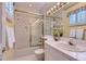Traditional bathroom with a shower over tub, a vanity, and decorative window coverings at 32 Silver Fox Cir, Greenwood Village, CO 80121
