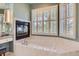 Large soaking tub with marble tile surround, a vanity, and a window with plantation shutters at 32 Silver Fox Cir, Greenwood Village, CO 80121
