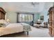 Serene main bedroom featuring a tray ceiling, large window, sitting area, and ample natural light at 32 Silver Fox Cir, Greenwood Village, CO 80121