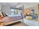 Bright bedroom with large windows offering views of the landscaped outdoors at 32 Silver Fox Cir, Greenwood Village, CO 80121