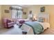 Bright bedroom featuring two twin beds, a large window, and a comfortable rocking chair at 32 Silver Fox Cir, Greenwood Village, CO 80121