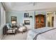 Inviting main bedroom with fireplace, tray ceiling, neutral carpet, and cozy sitting area at 32 Silver Fox Cir, Greenwood Village, CO 80121