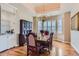 Formal dining room with chandelier, large windows, and a built-in cabinet at 32 Silver Fox Cir, Greenwood Village, CO 80121