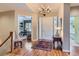 Elegant foyer with hardwood floors, chandelier lighting, and a view into the office at 32 Silver Fox Cir, Greenwood Village, CO 80121