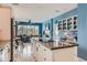 Open kitchen with white cabinetry, granite countertops, and an island cooktop offers ample prep space at 32 Silver Fox Cir, Greenwood Village, CO 80121