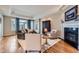 Cozy living room features a fireplace, hardwood floors, and tray ceilings, creating a comfortable space at 32 Silver Fox Cir, Greenwood Village, CO 80121